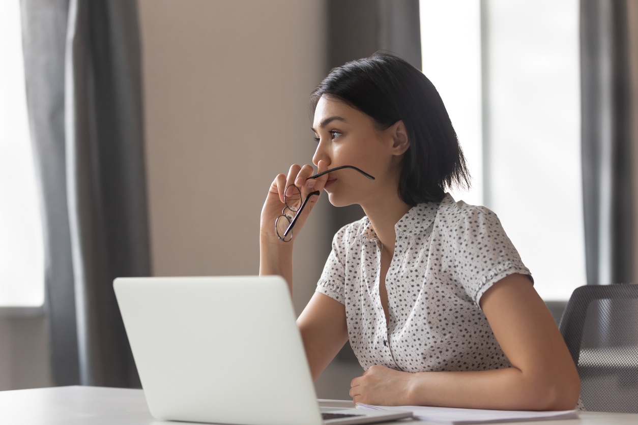 Woman with concerned expression looking off in to distance