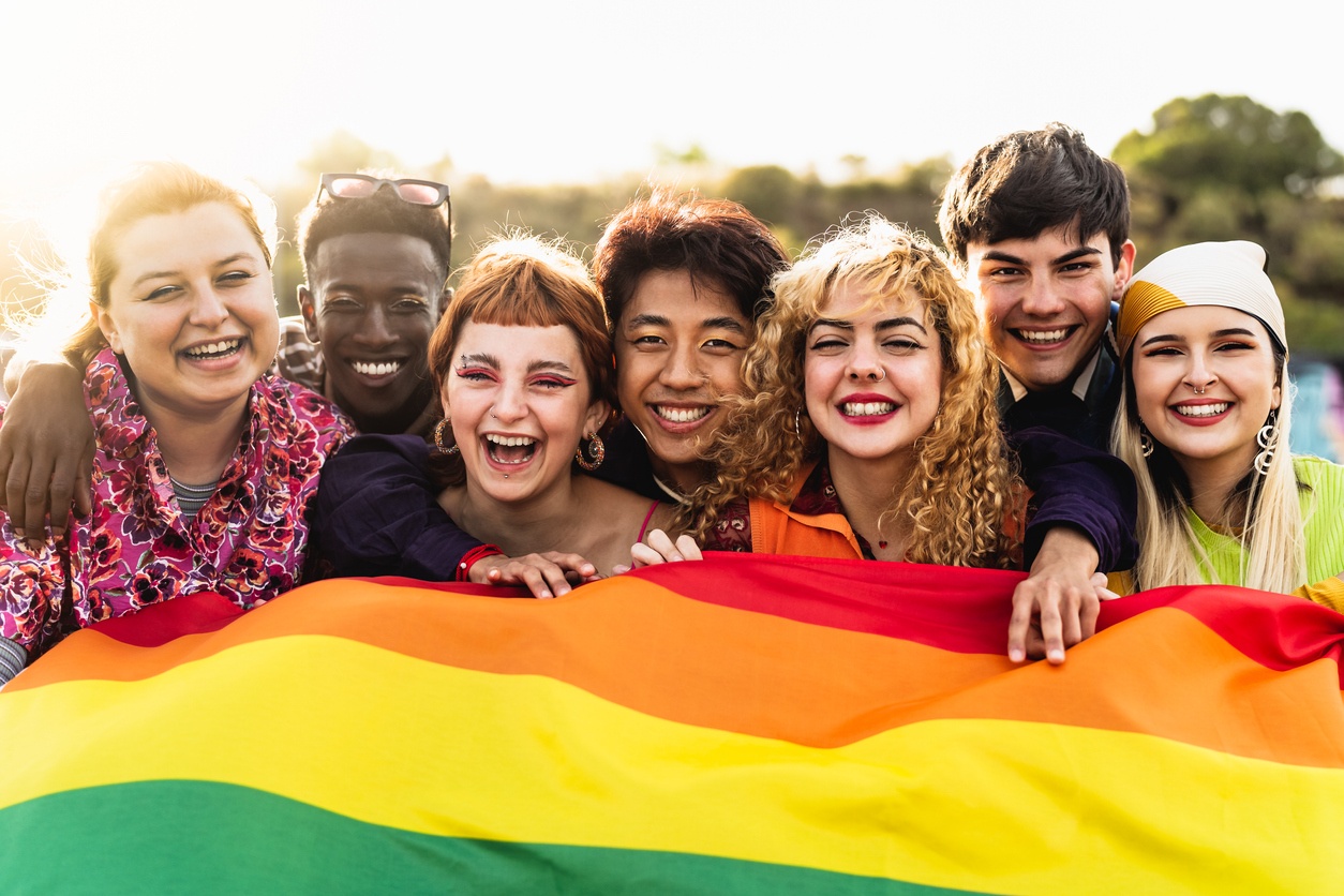 Group of people holding pride flag