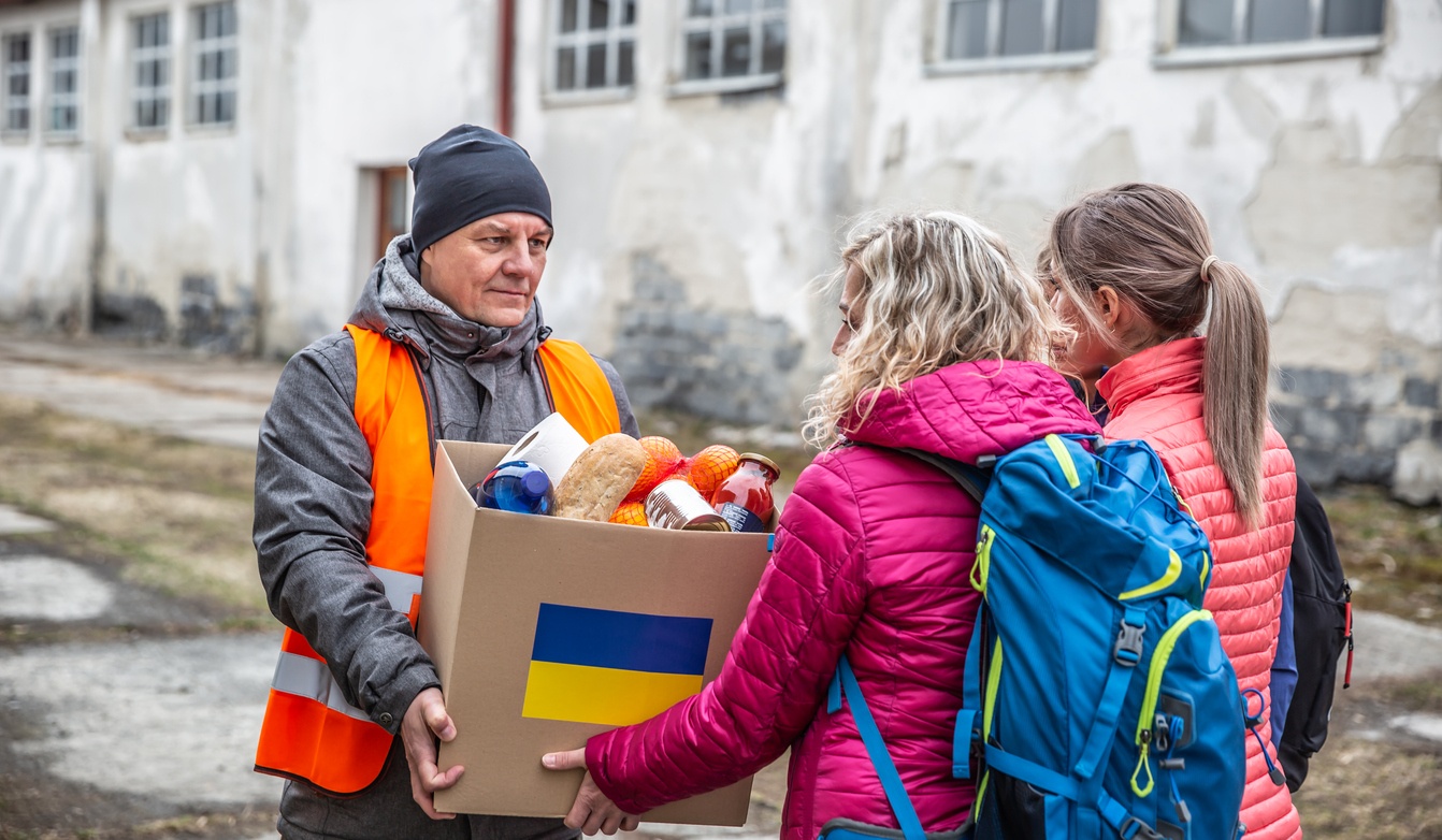 Volunteer giving box of food