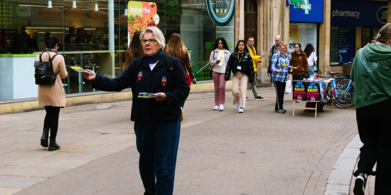 women giving pamphlets